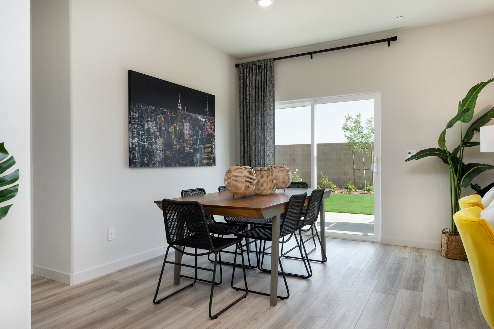 A dining room with a table and chairs.