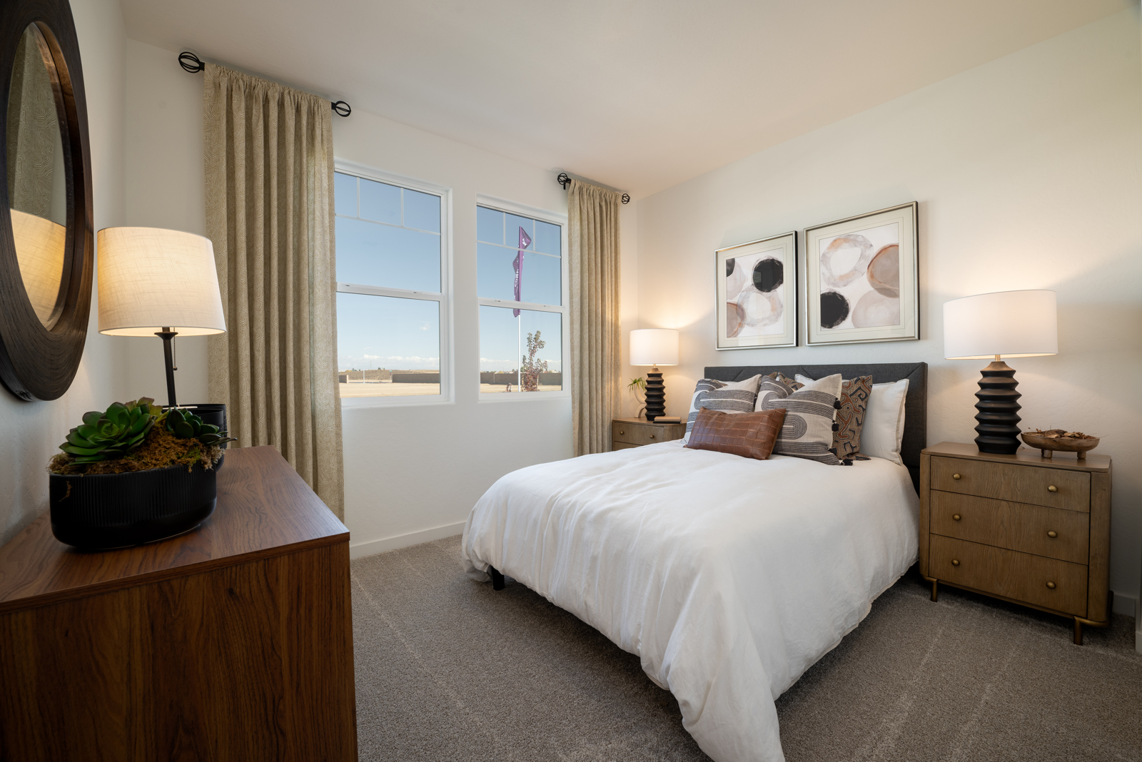 A bedroom with a bed and lamps.