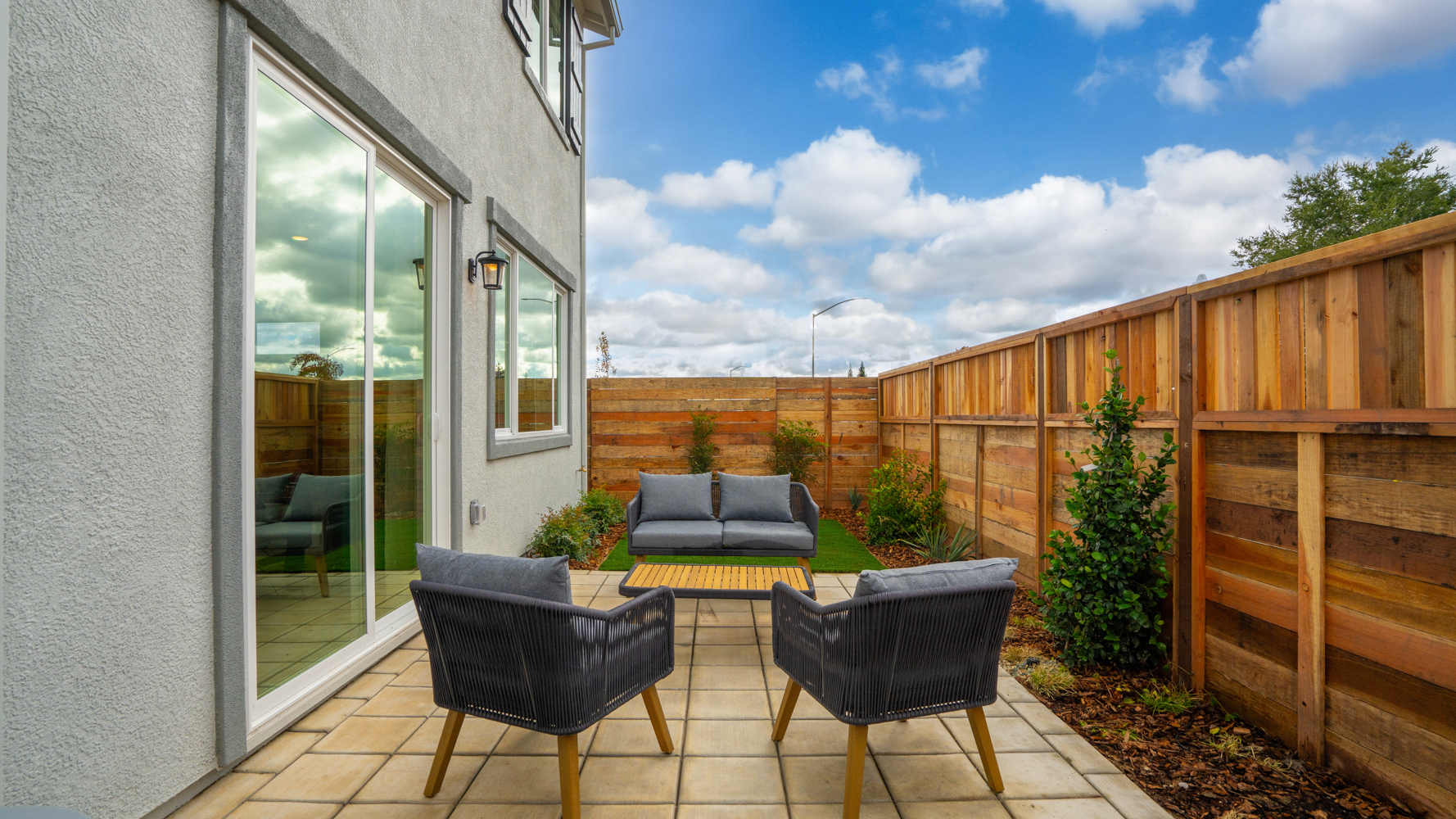 A deck with chairs and a table.