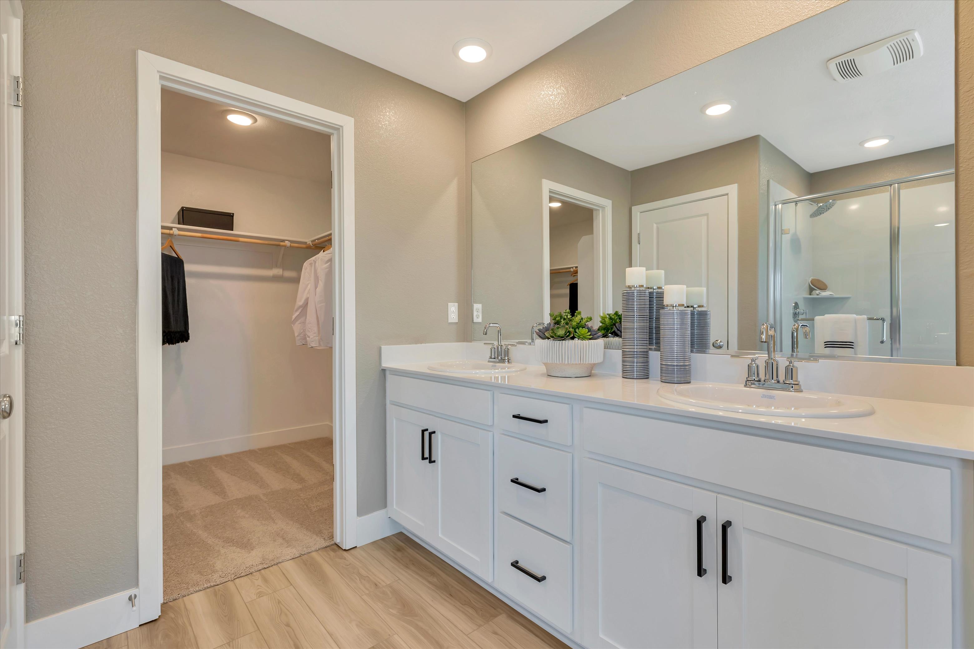 A bathroom with a large mirror.