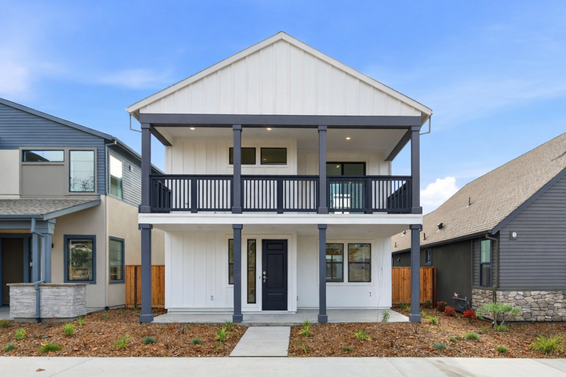 A house with a porch with Southfork Ranch in the background.