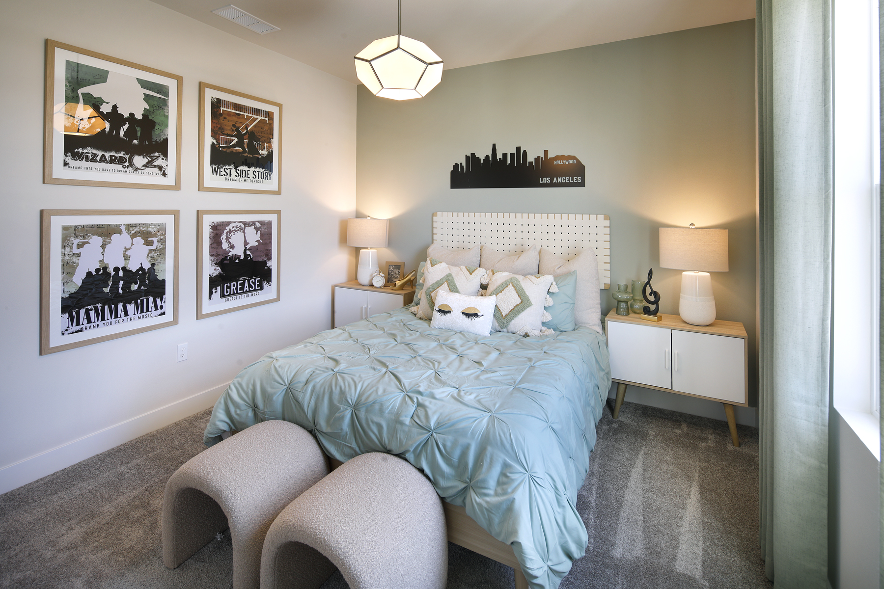 A bedroom with a bed and a chair.