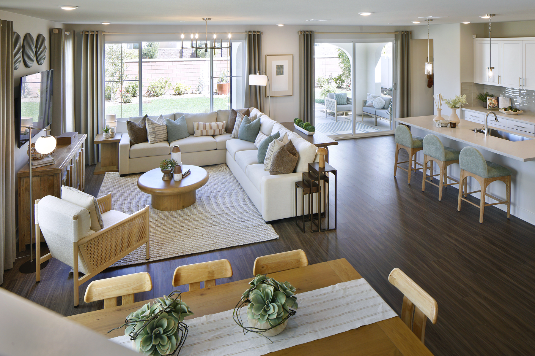 A living room with a large rug and a large dining table.