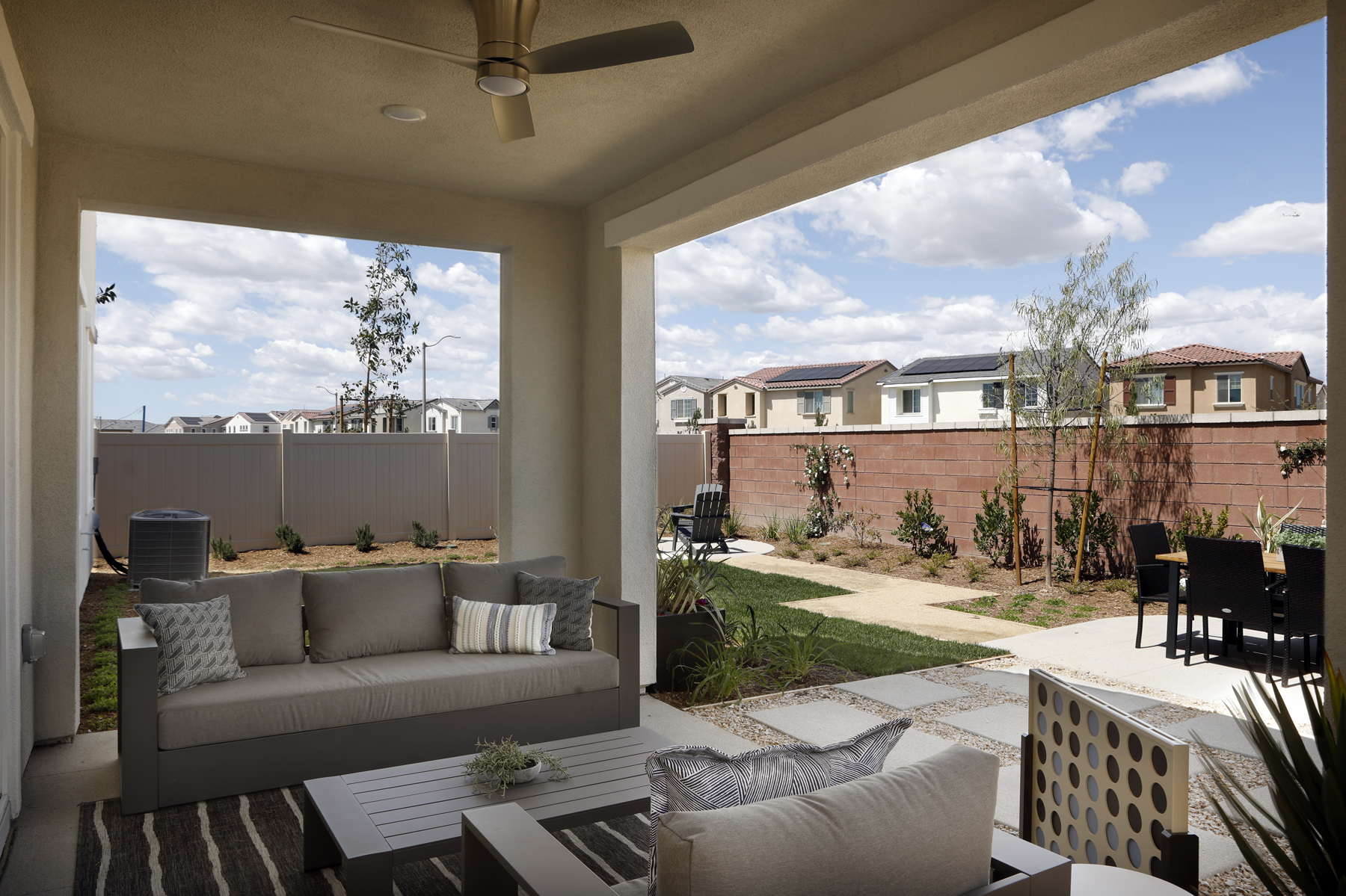 A patio with a couch and chairs.