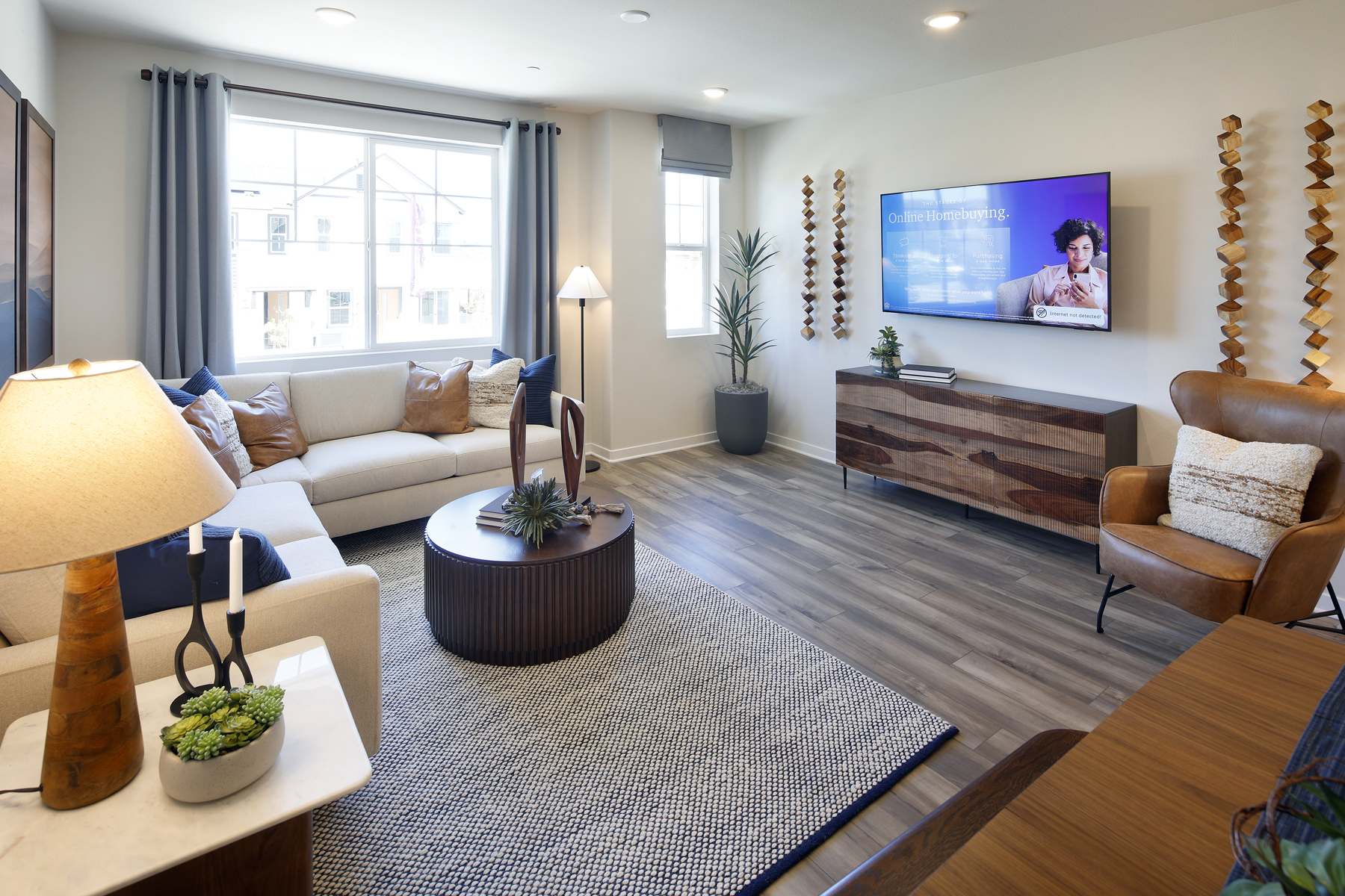 A living room with a rug and a tv.