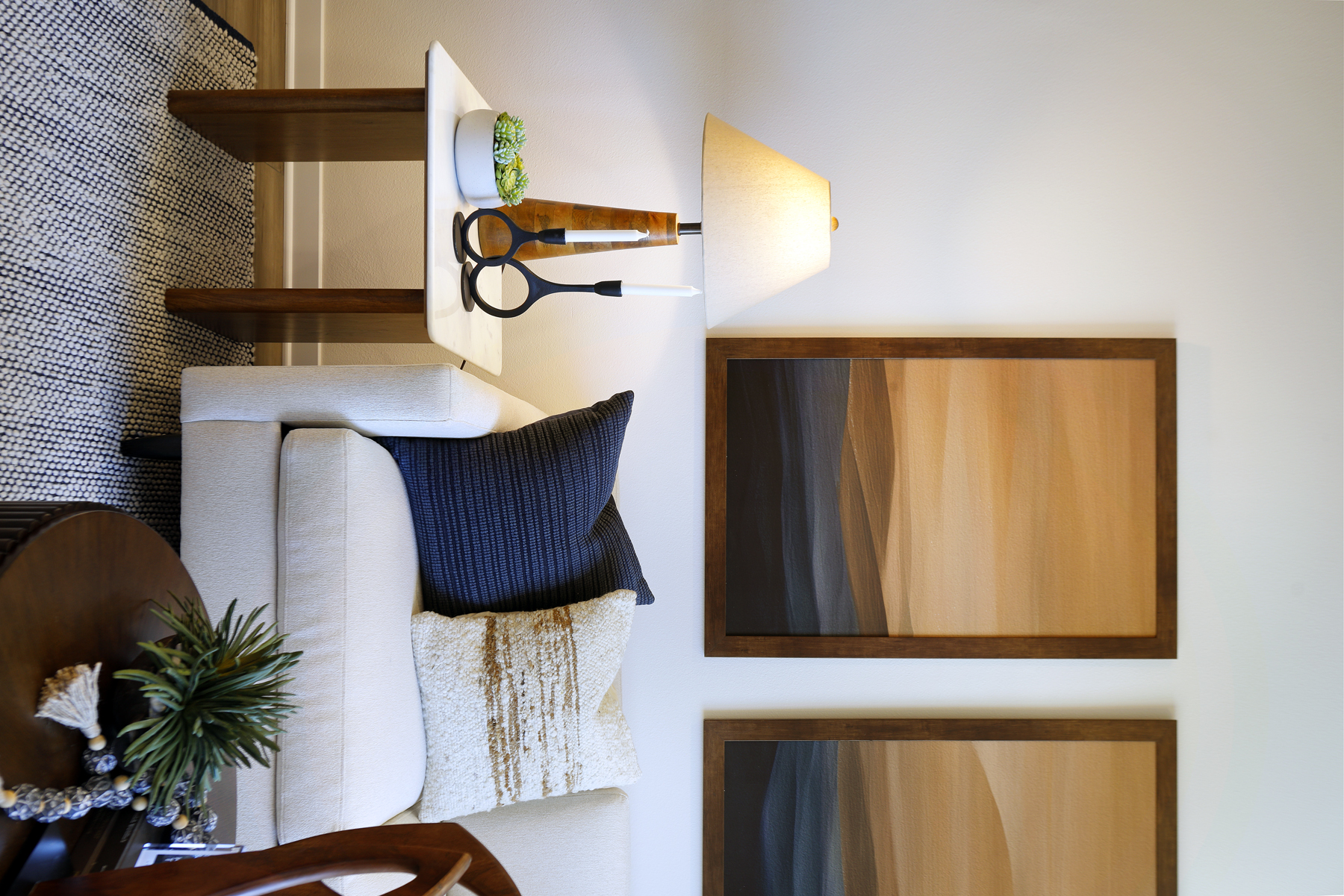 A white couch with a blue pillow.