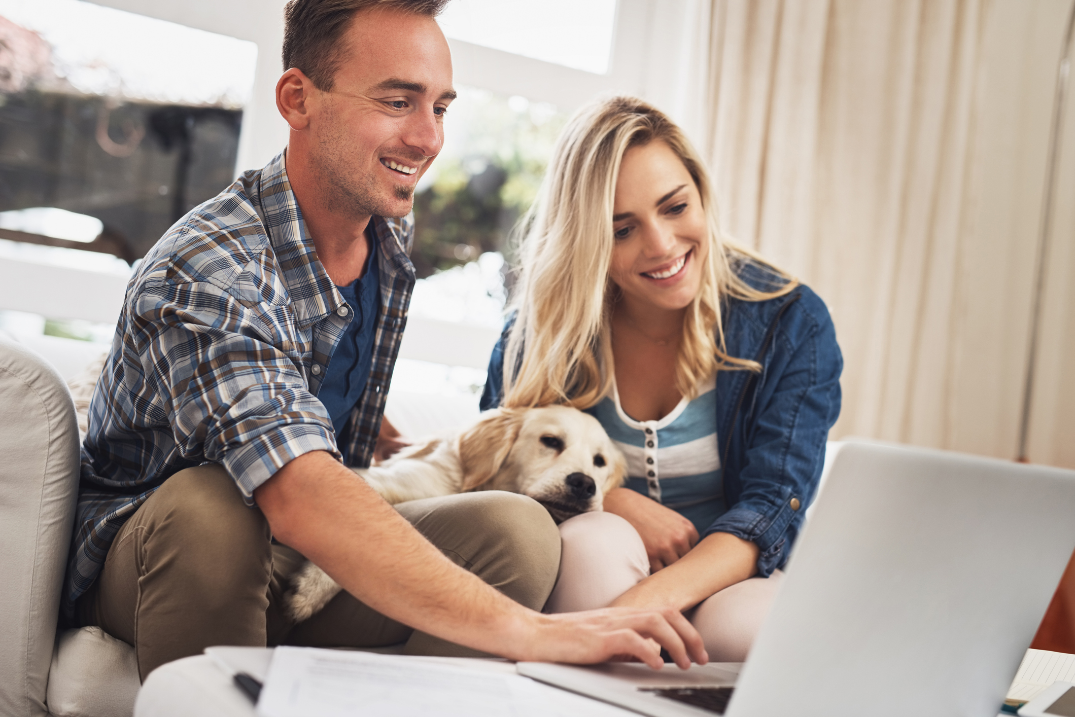 A man and a woman looking at a laptop.