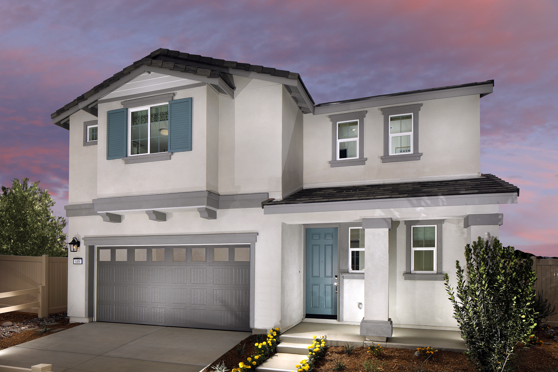 A white house with a garage.