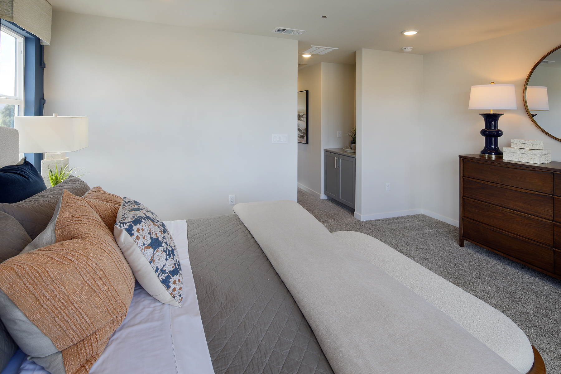A living room with a couch and a lamp.