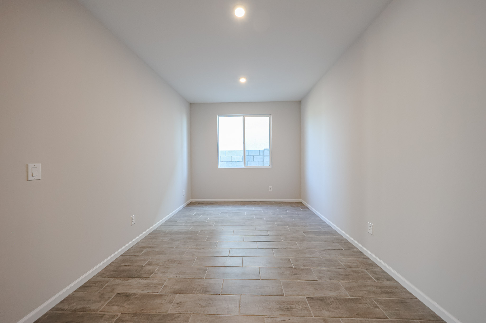 A room with a tile floor and a window.