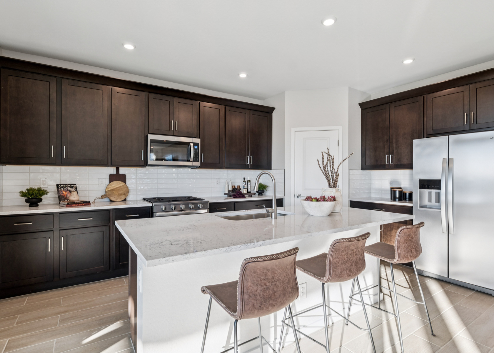 A kitchen with a table and chairs.