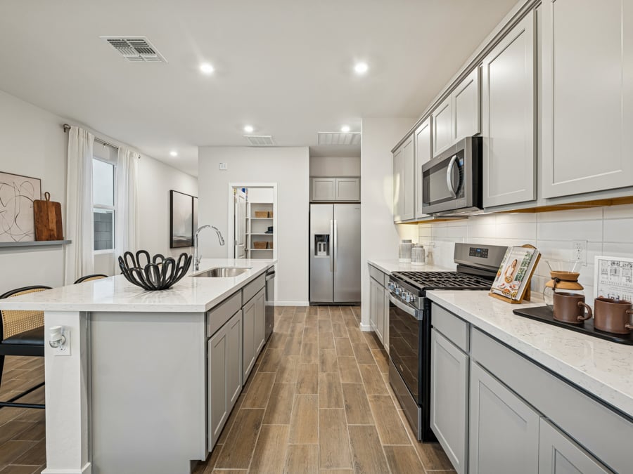 A kitchen with white cabinets.