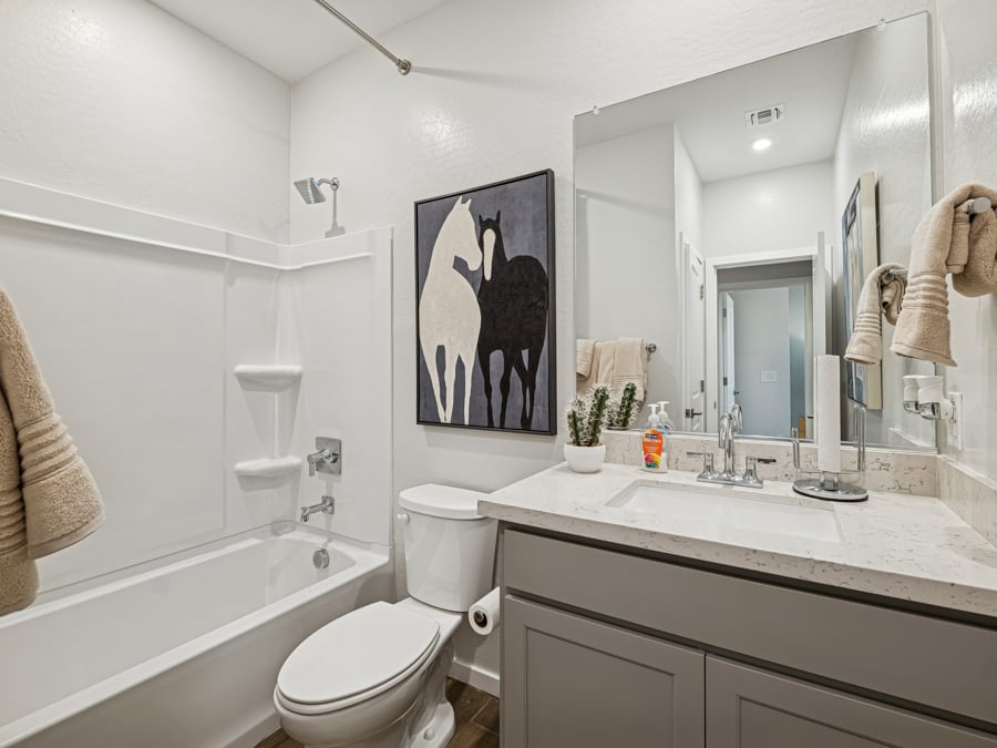 A bathroom with a large mirror.