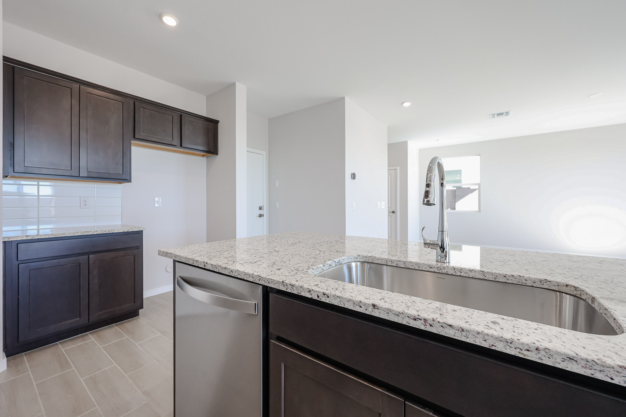 A large kitchen with marble counters.