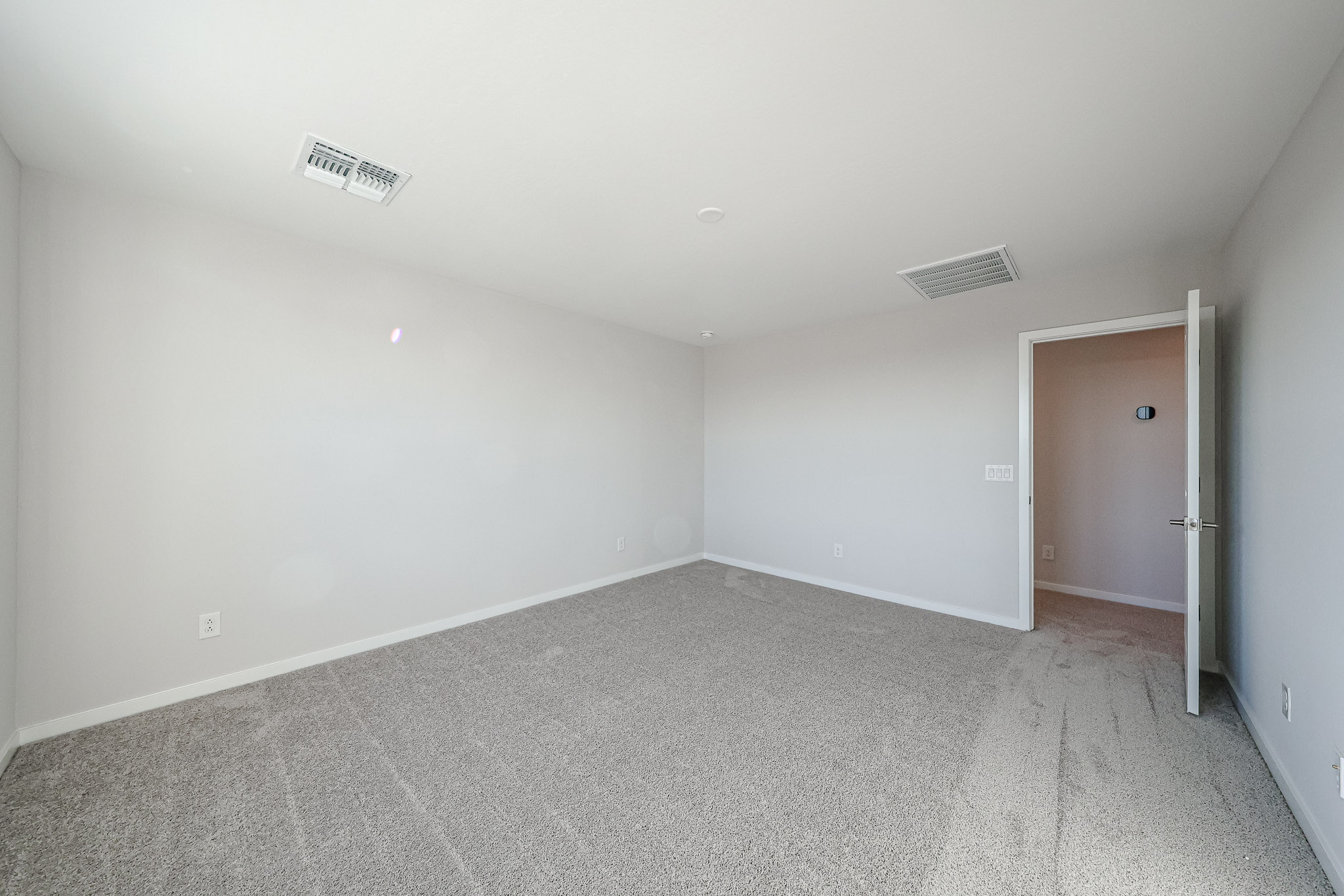 A hallway with a door and a window.