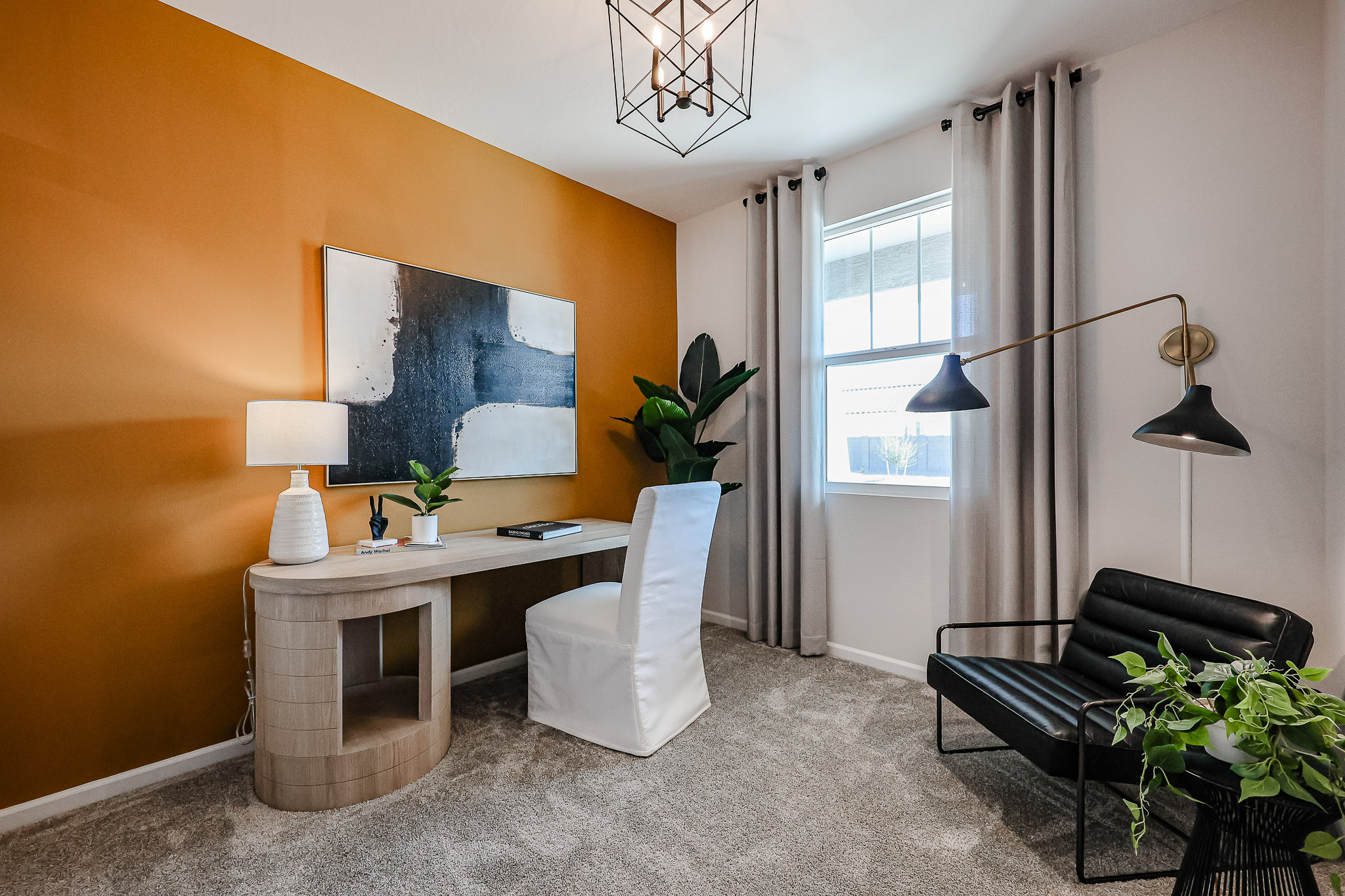 A room with a desk and chairs.