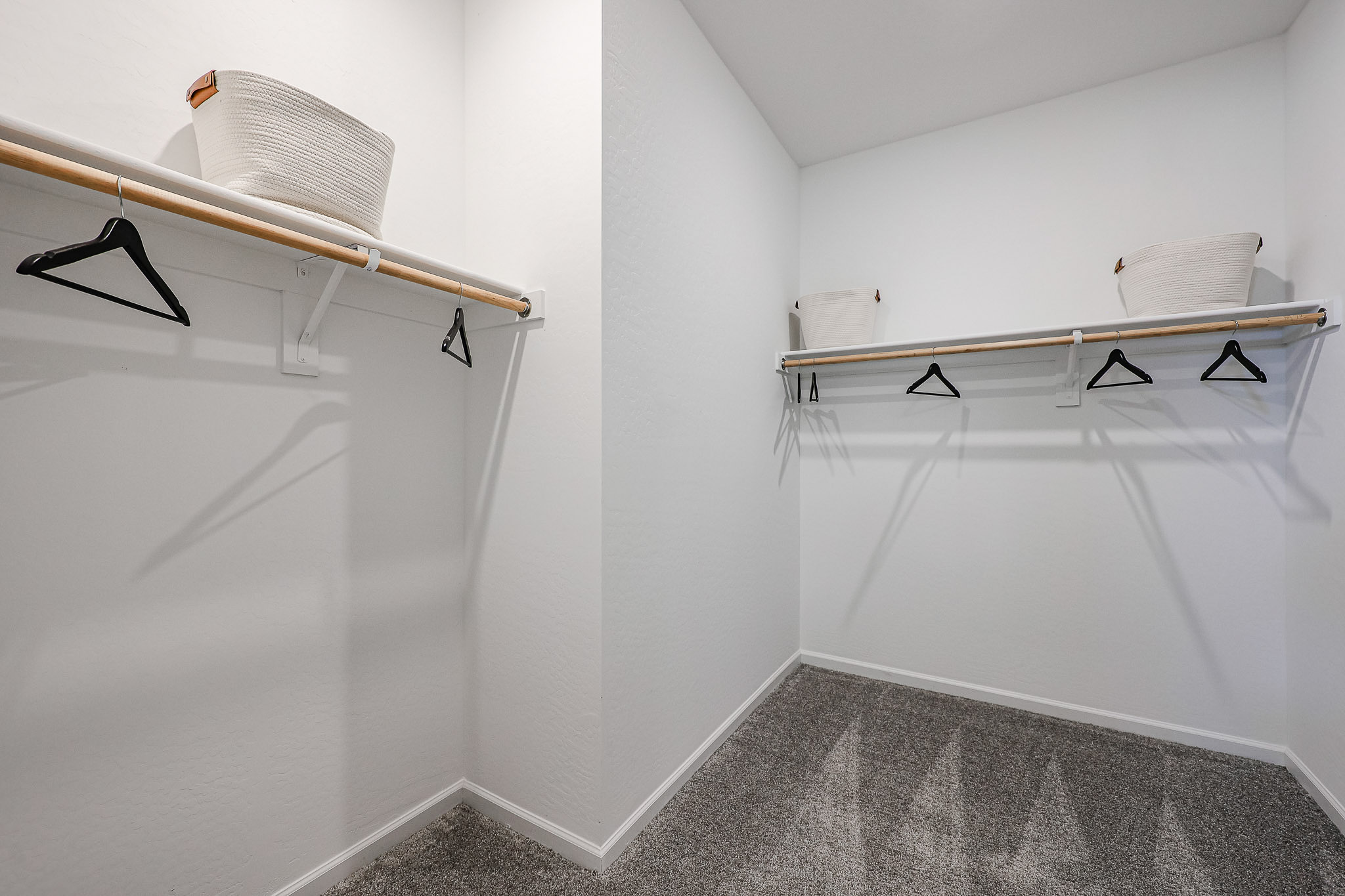 A white room with a bed and a chair.