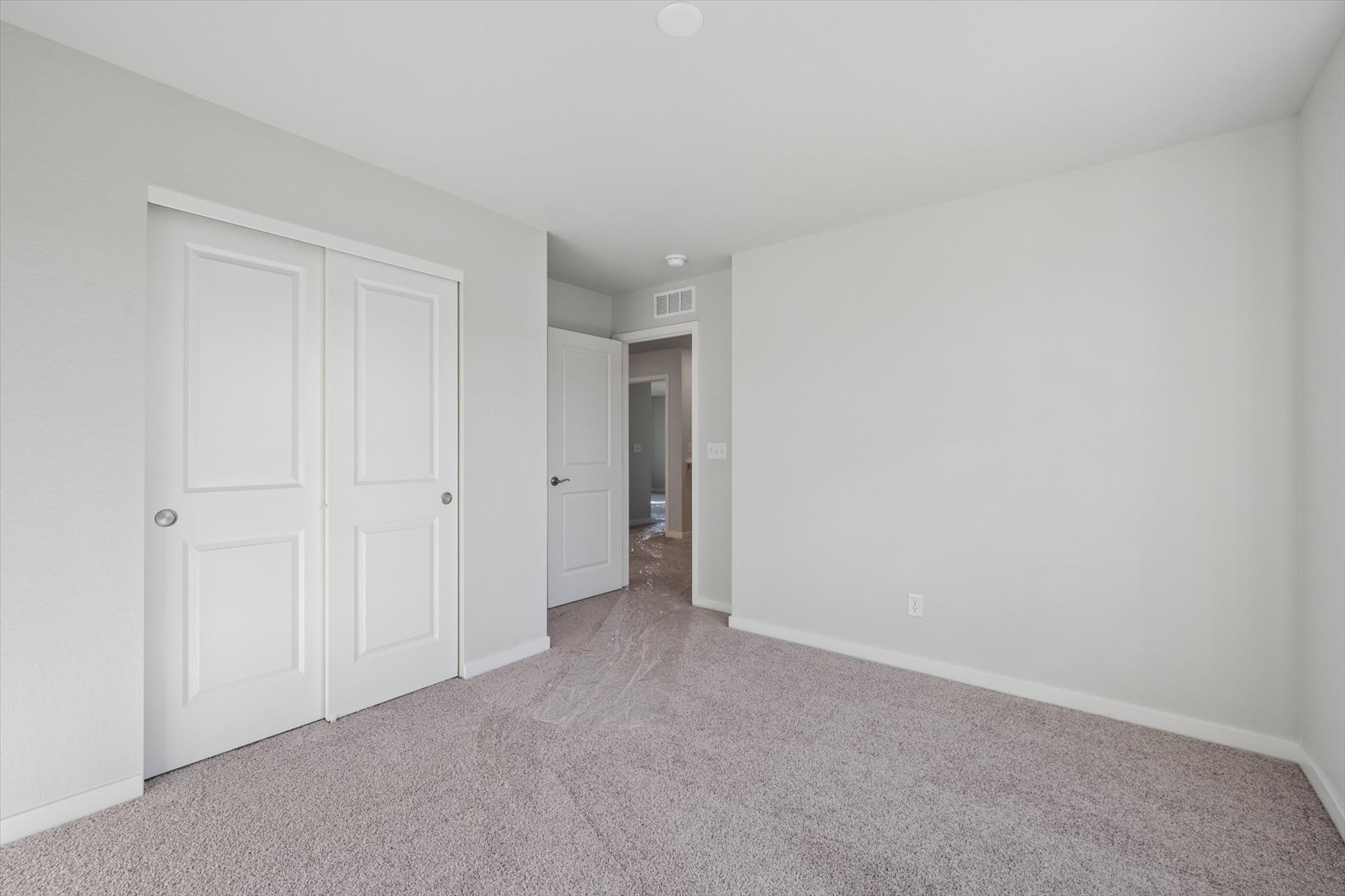 A hallway with white doors.