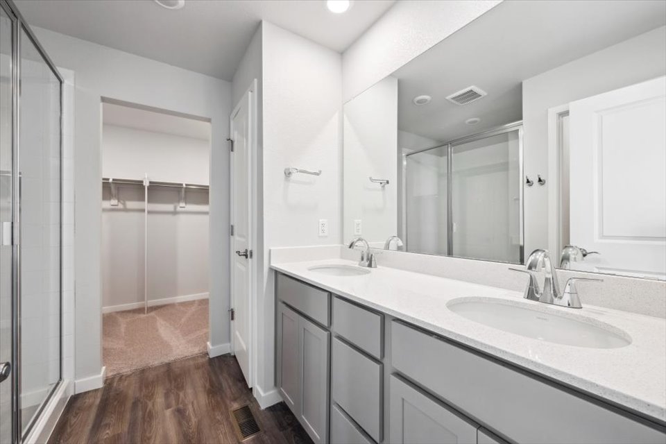 A bathroom with a large mirror.