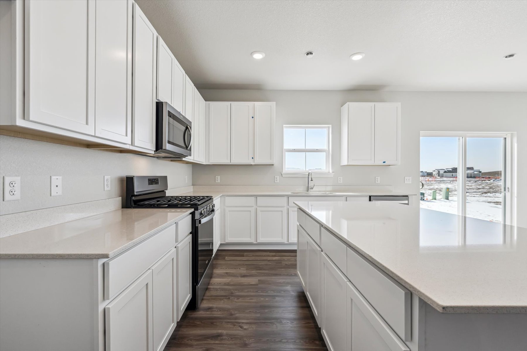 A kitchen with white cabinets.