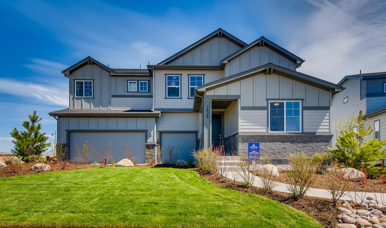 A house with a green lawn.
