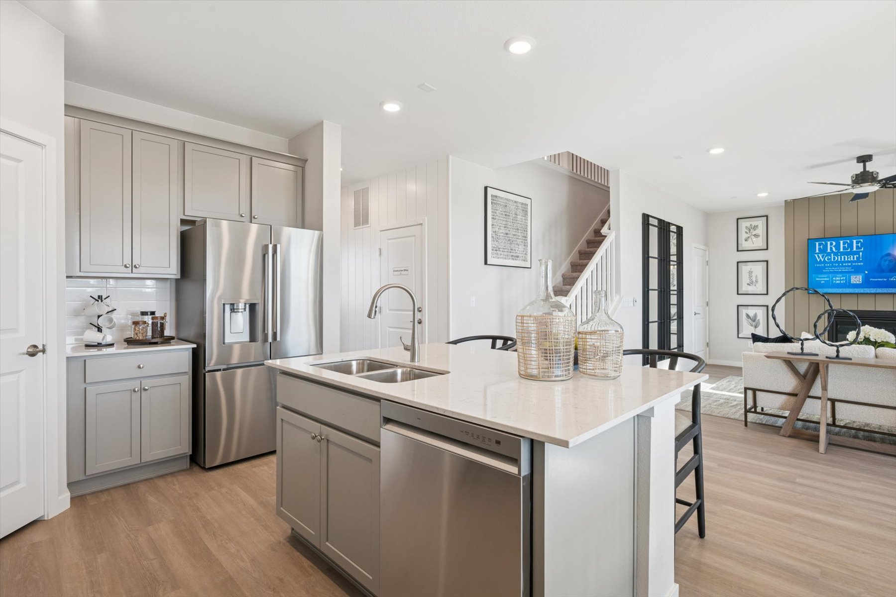 A kitchen with white cabinets.