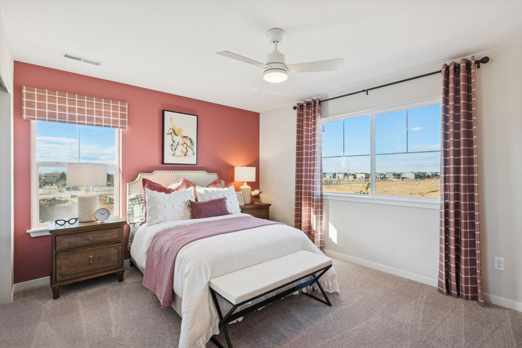 A bedroom with a large window.