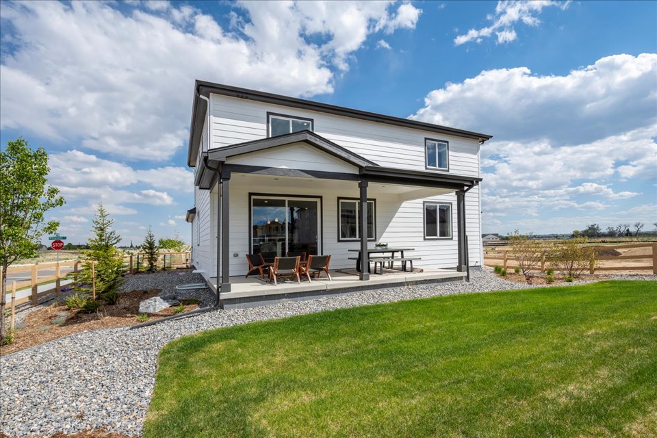 A house with a lawn and a fence.