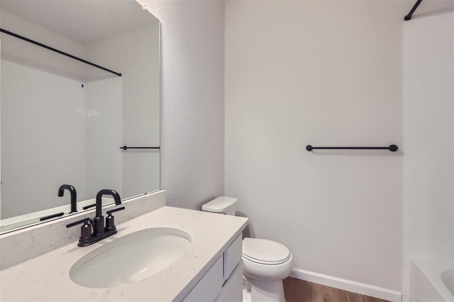 A bathroom with a sink and toilet.