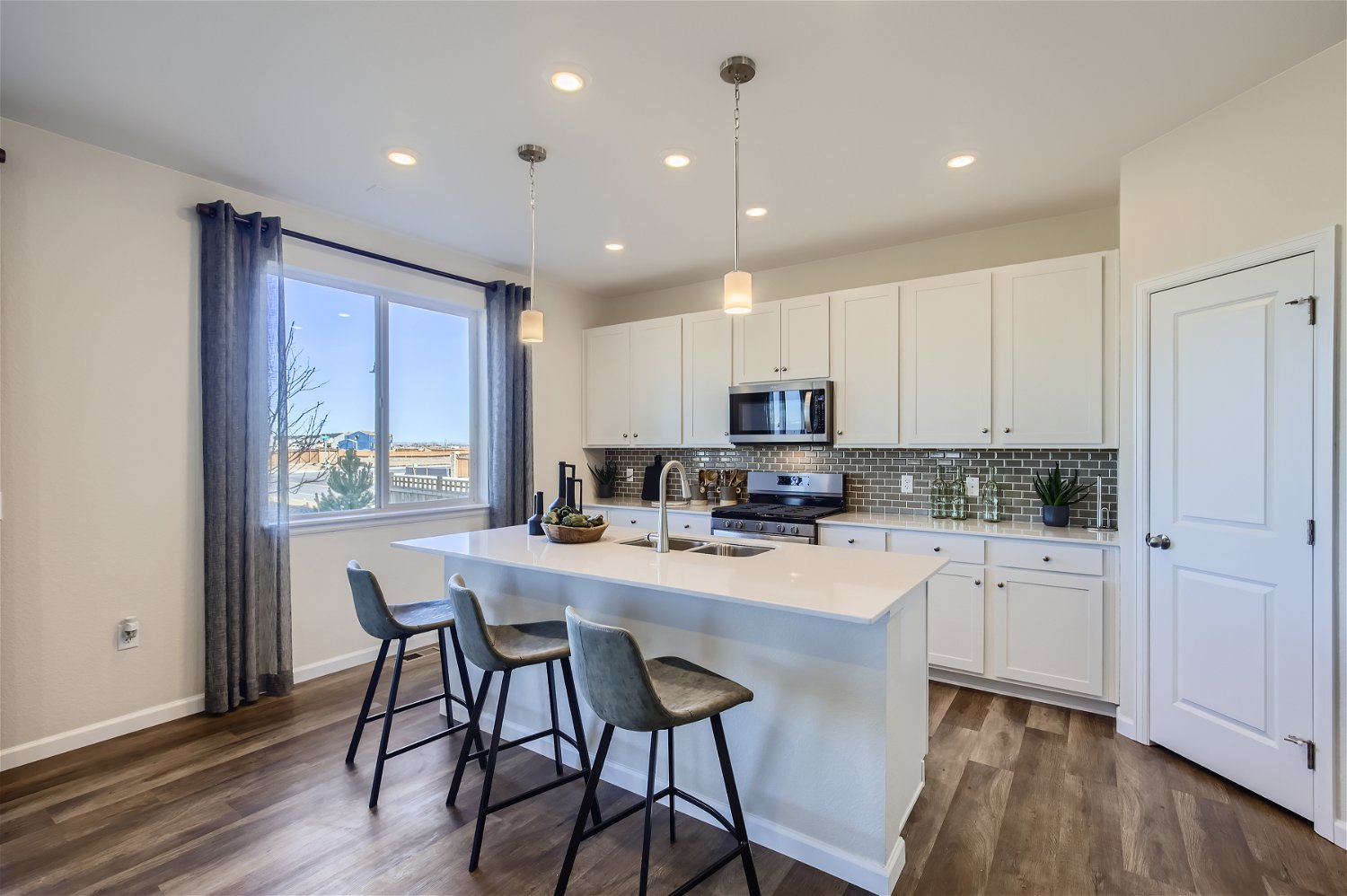 A kitchen with white cabinets.