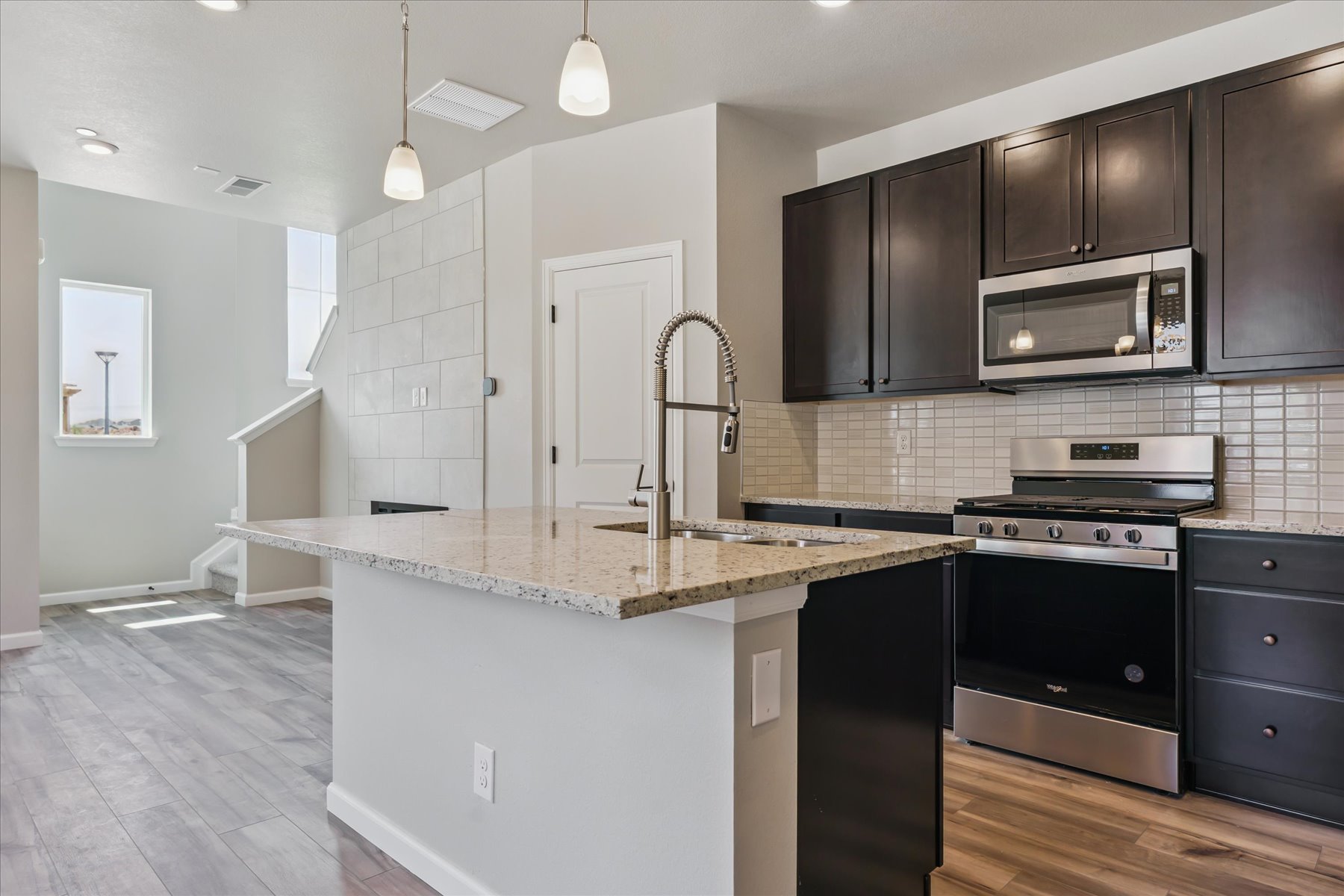 A kitchen with black cabinets.