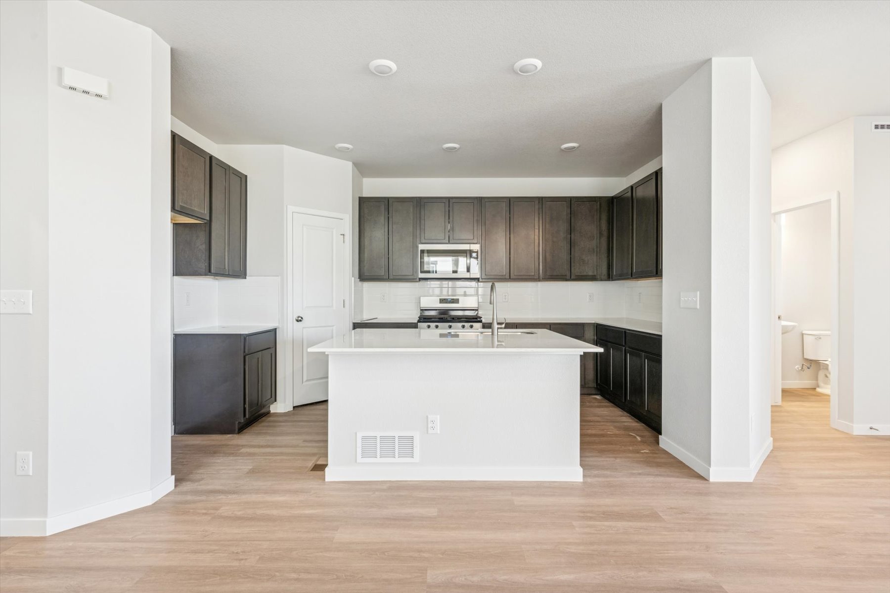 A kitchen with a white counter.