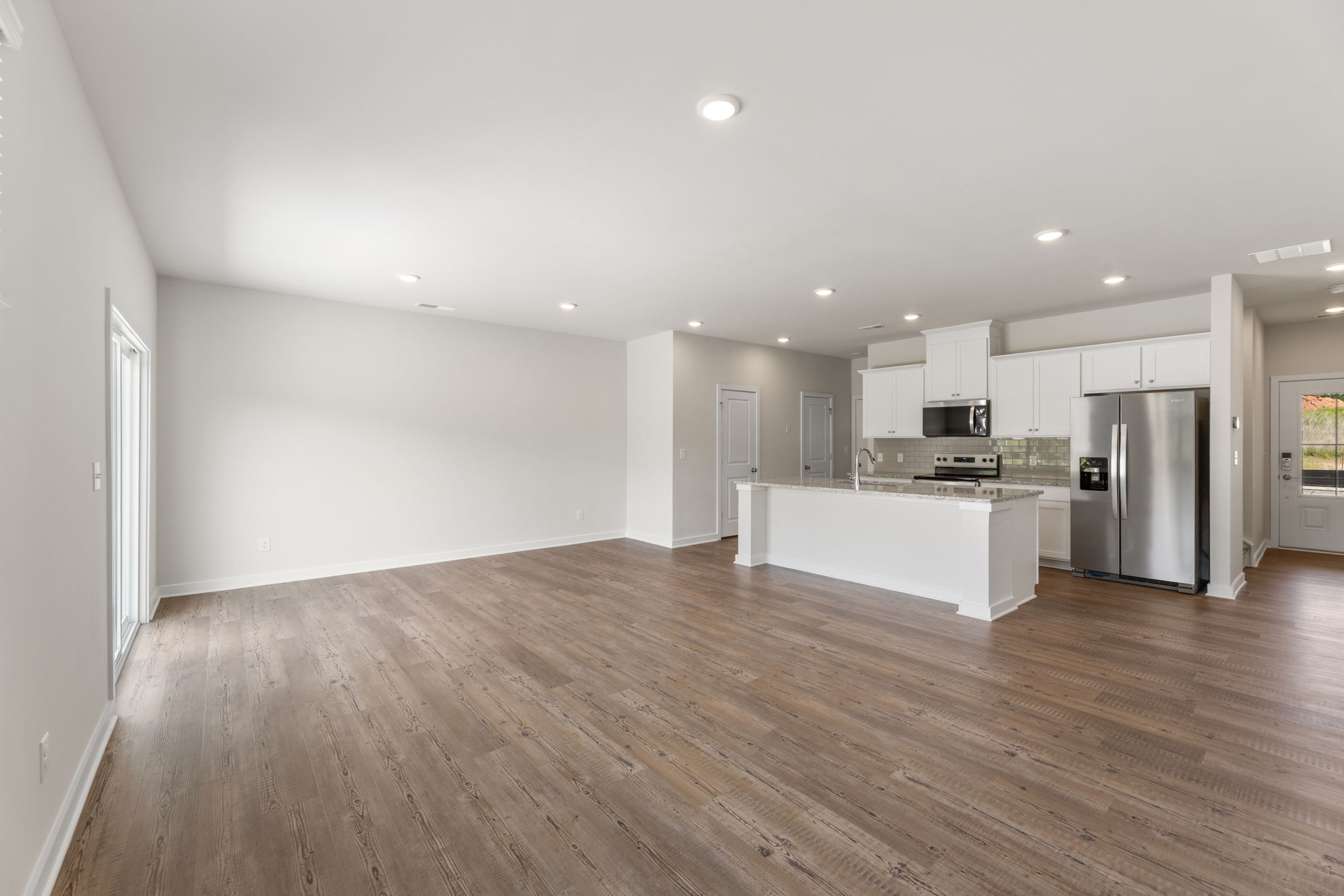 A large kitchen with white cabinets.