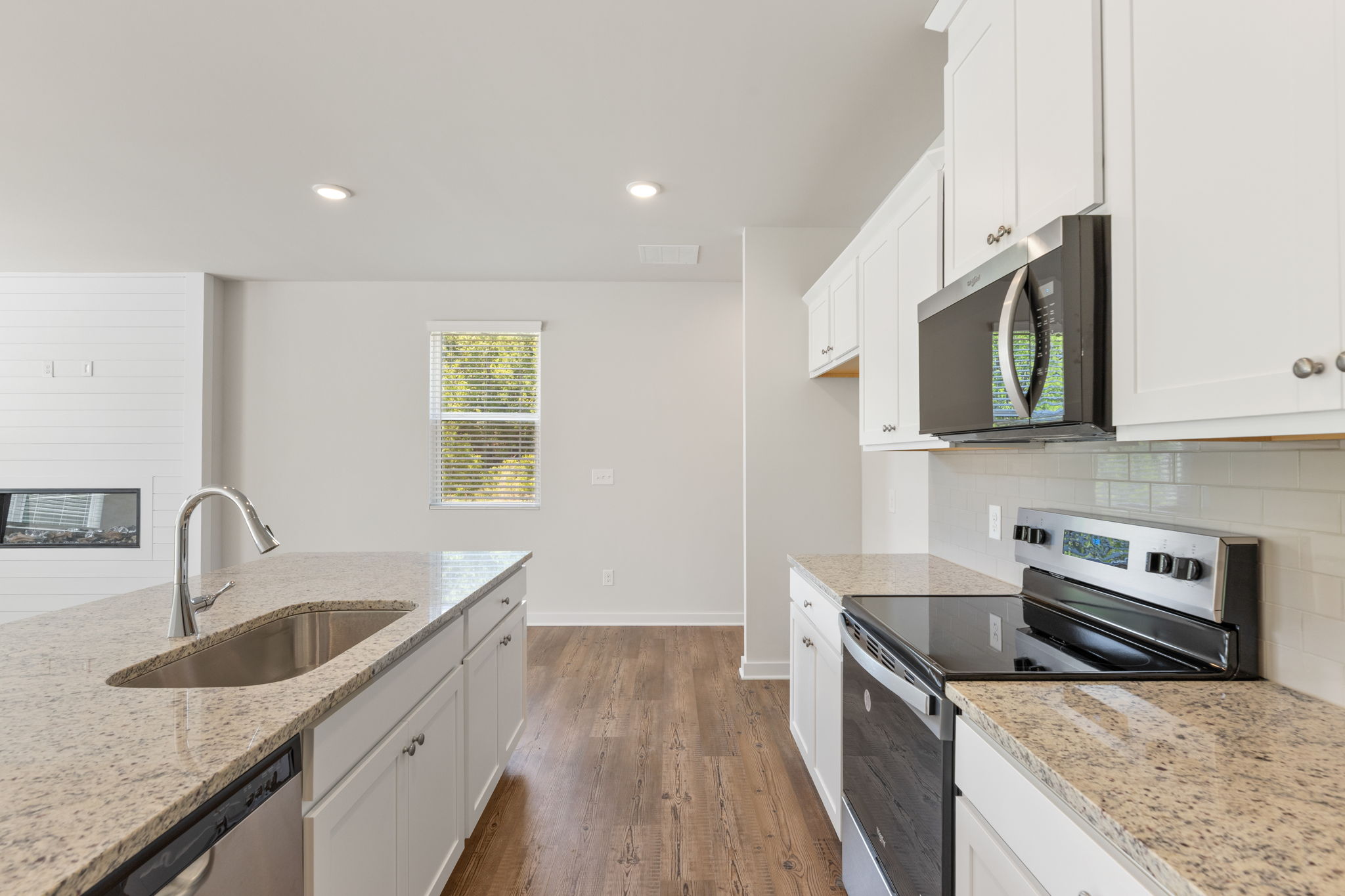 A kitchen with white cabinets.