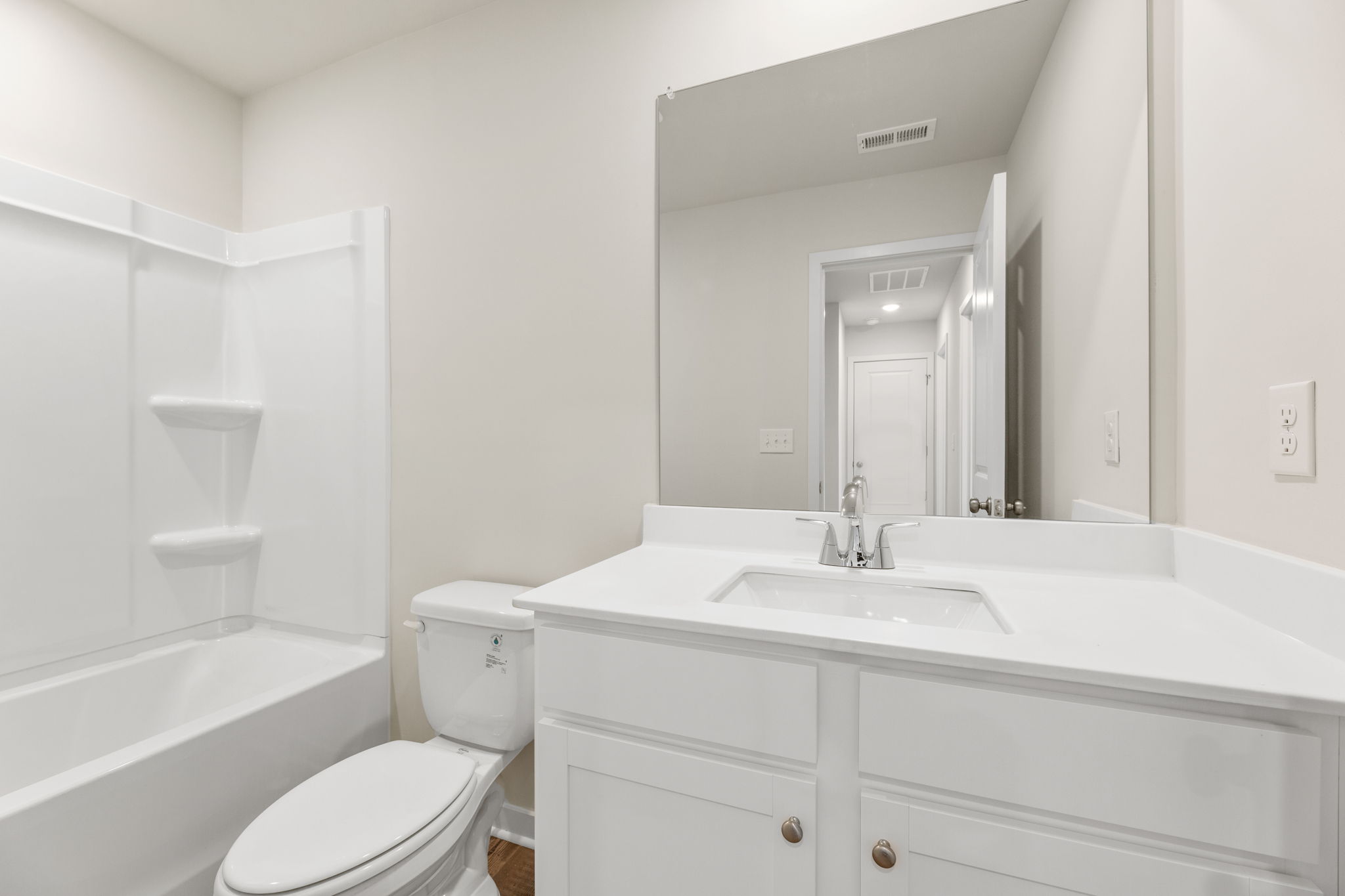 A bathroom with a tub sink and toilet.