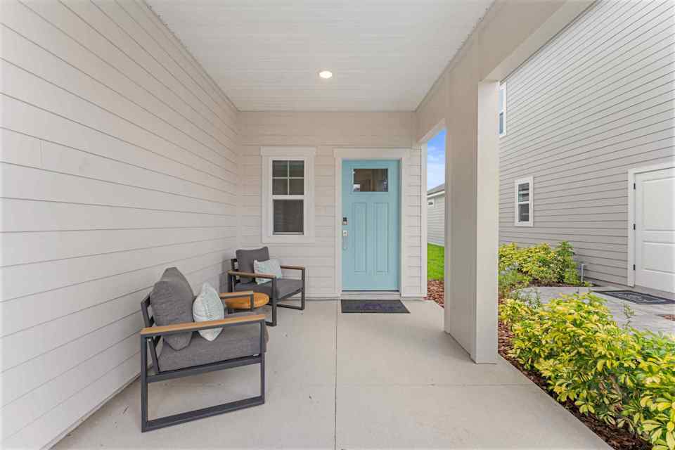 Laurel II Model Home Front Patio Entrance with Blue Door at Camden Woods in Kingsland, GA