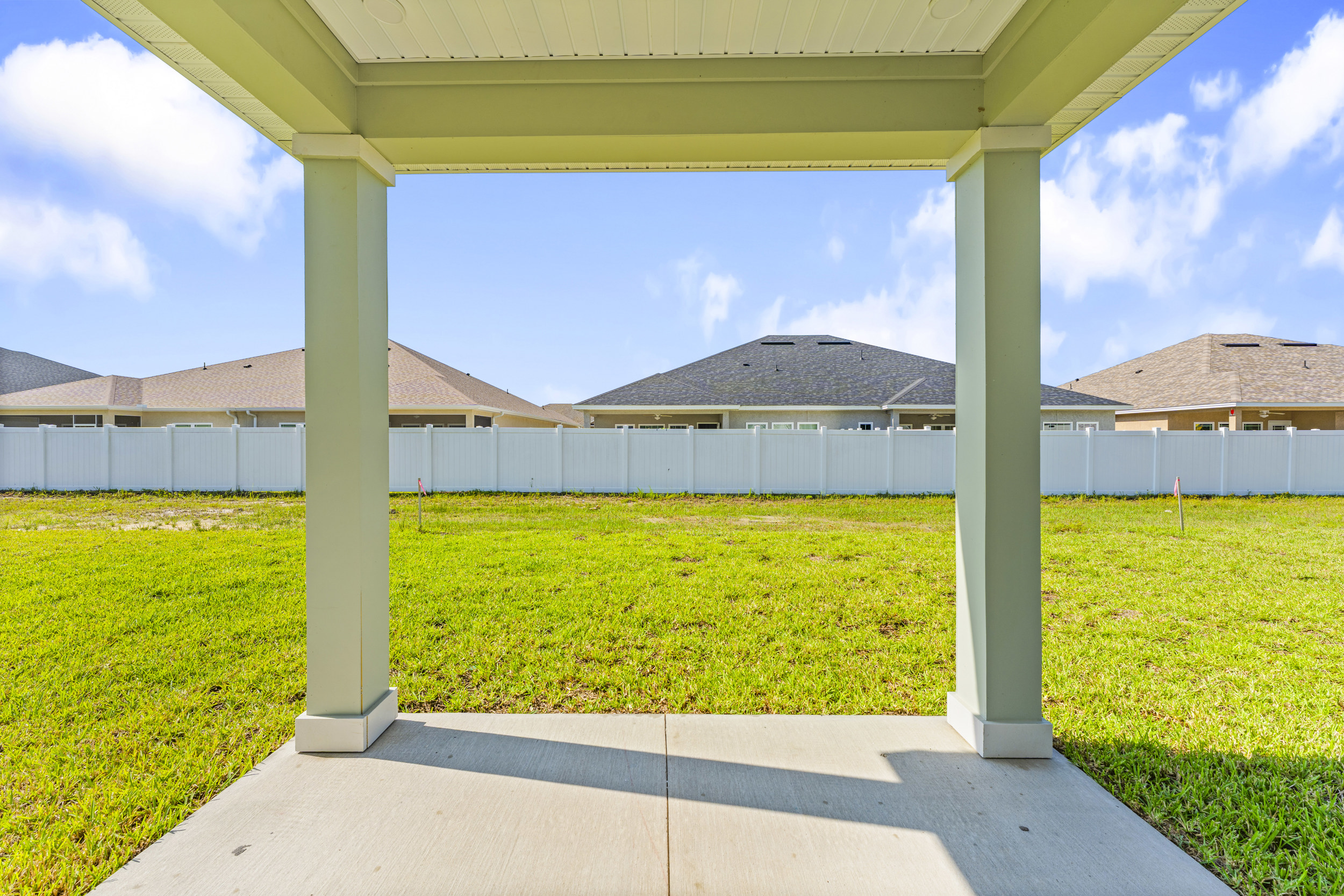 Lot 19 Cedar II Covered Patio with View of Backyard and Privacy Wall at Camden Woods in Kingsland, GA