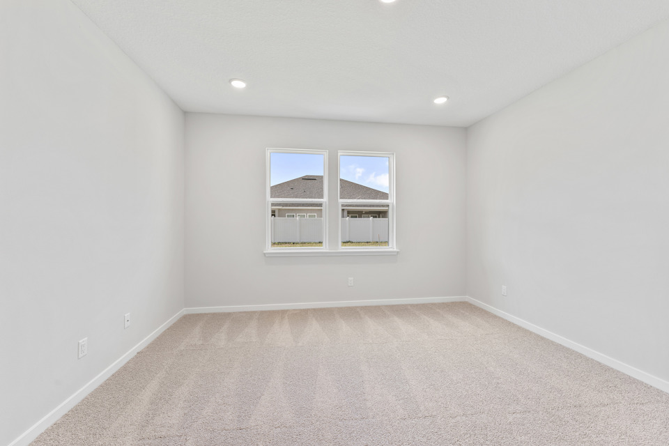 Primary Bedroom with Large Windows in Lot 19 Cedar II at Camden Woods in Kingsland, GA