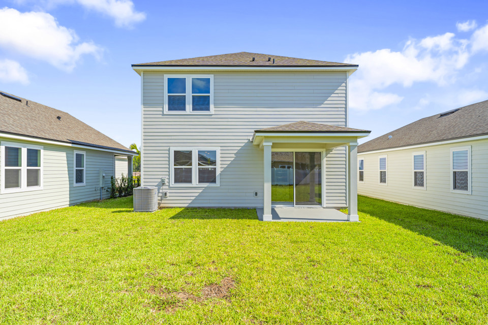 Lot 20 Ponderosa II Back Exterior of Home with Covered Patio at Camden Woods in Kingsland, GA