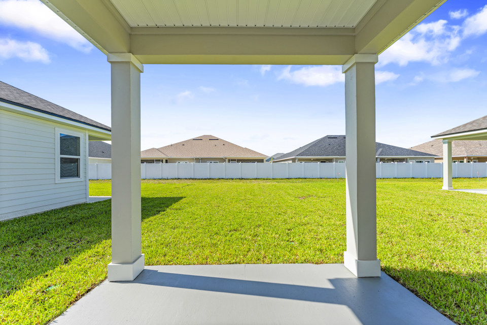 Lot 20 Ponderosa II Covered Patio with View of Backyard and Privacy Fence at Camden Woods in Kingsland, GA