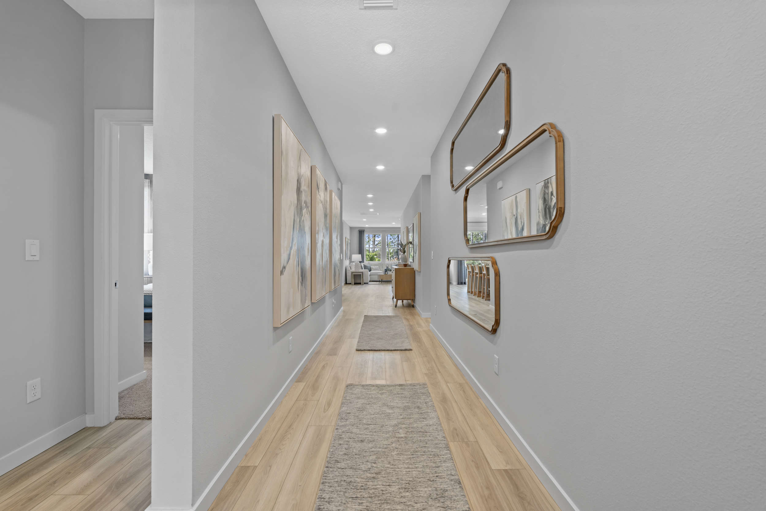Coronado Model Home Entryway with a mirror and a rug at Reserve East in Flagler Beach