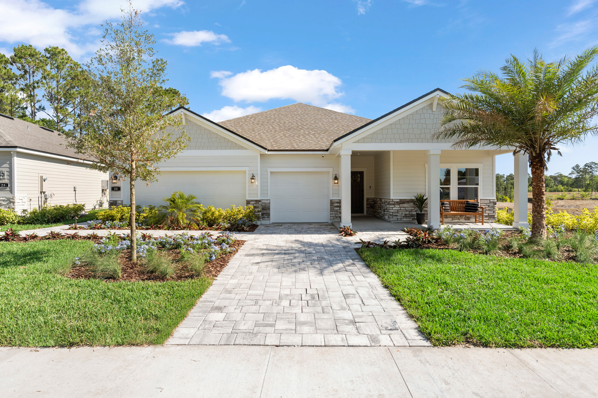 Kenai Model Home Exterior with 3-Bay Garage at Reserve East in Flagler Beach