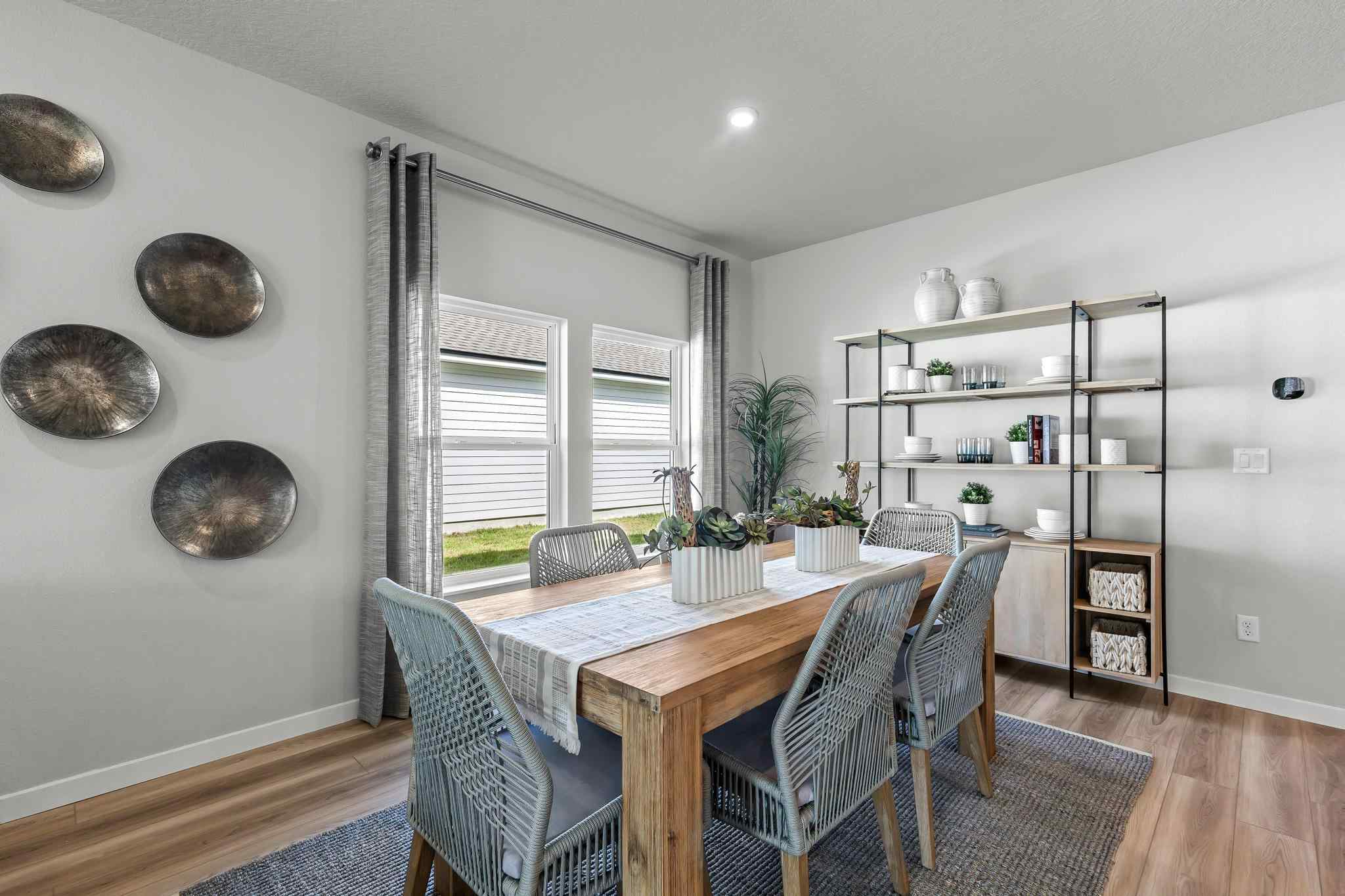 A dining room with a table and chairs.