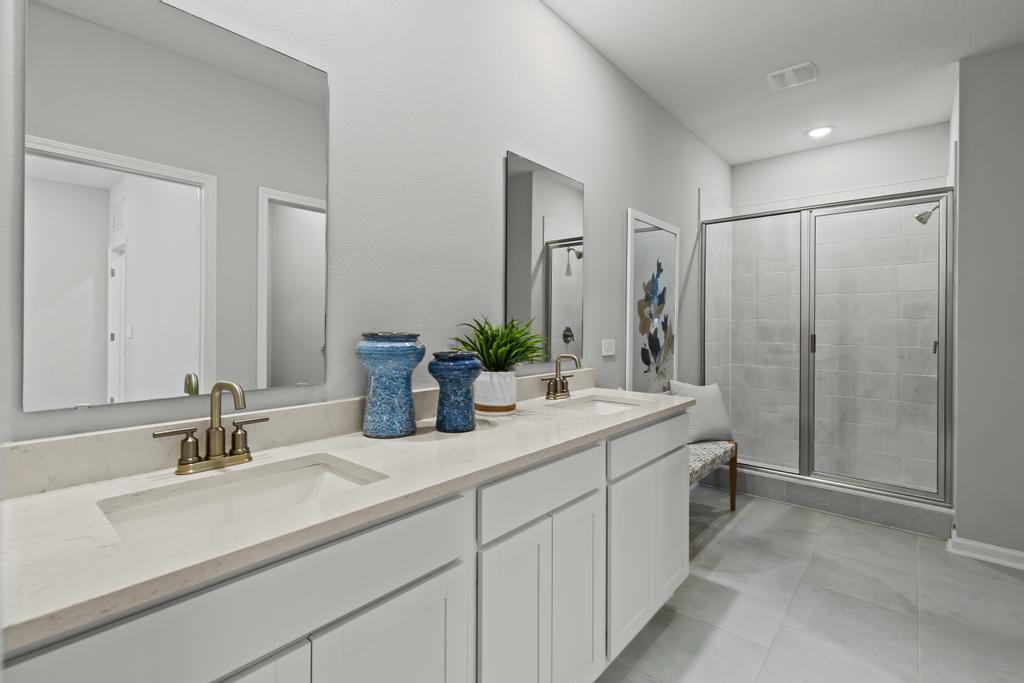 A bathroom with white cabinets.