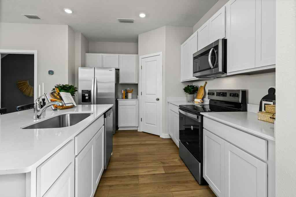 A kitchen with white cabinets.