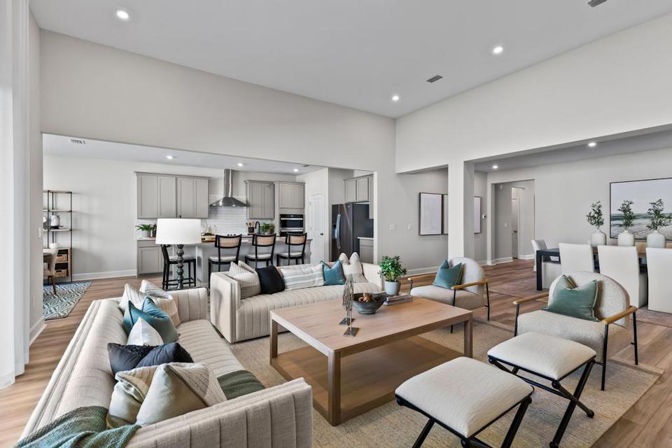 A living room with a large glass wall.