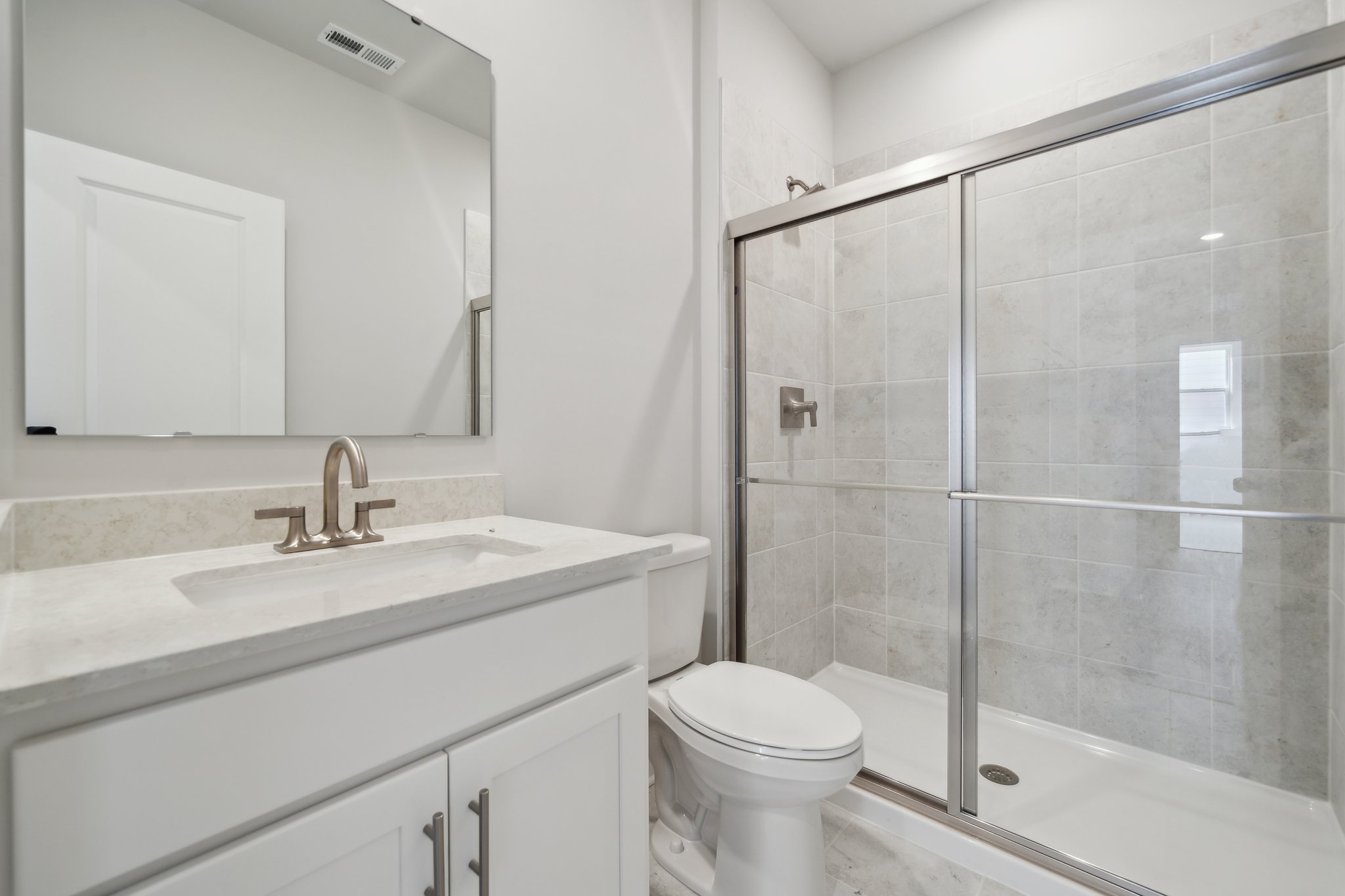 A bathroom with a glass shower.