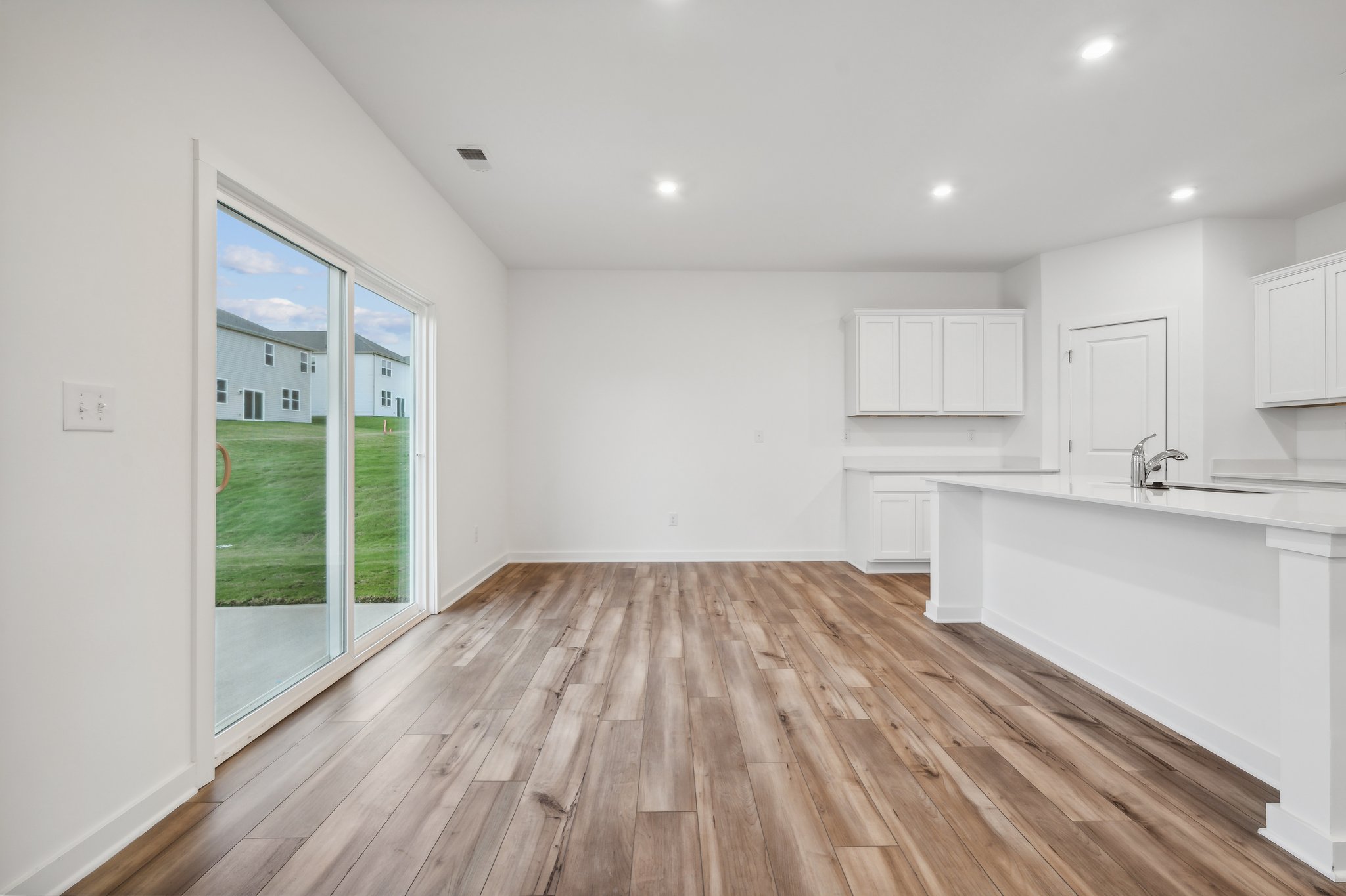 A kitchen with a wood floor.