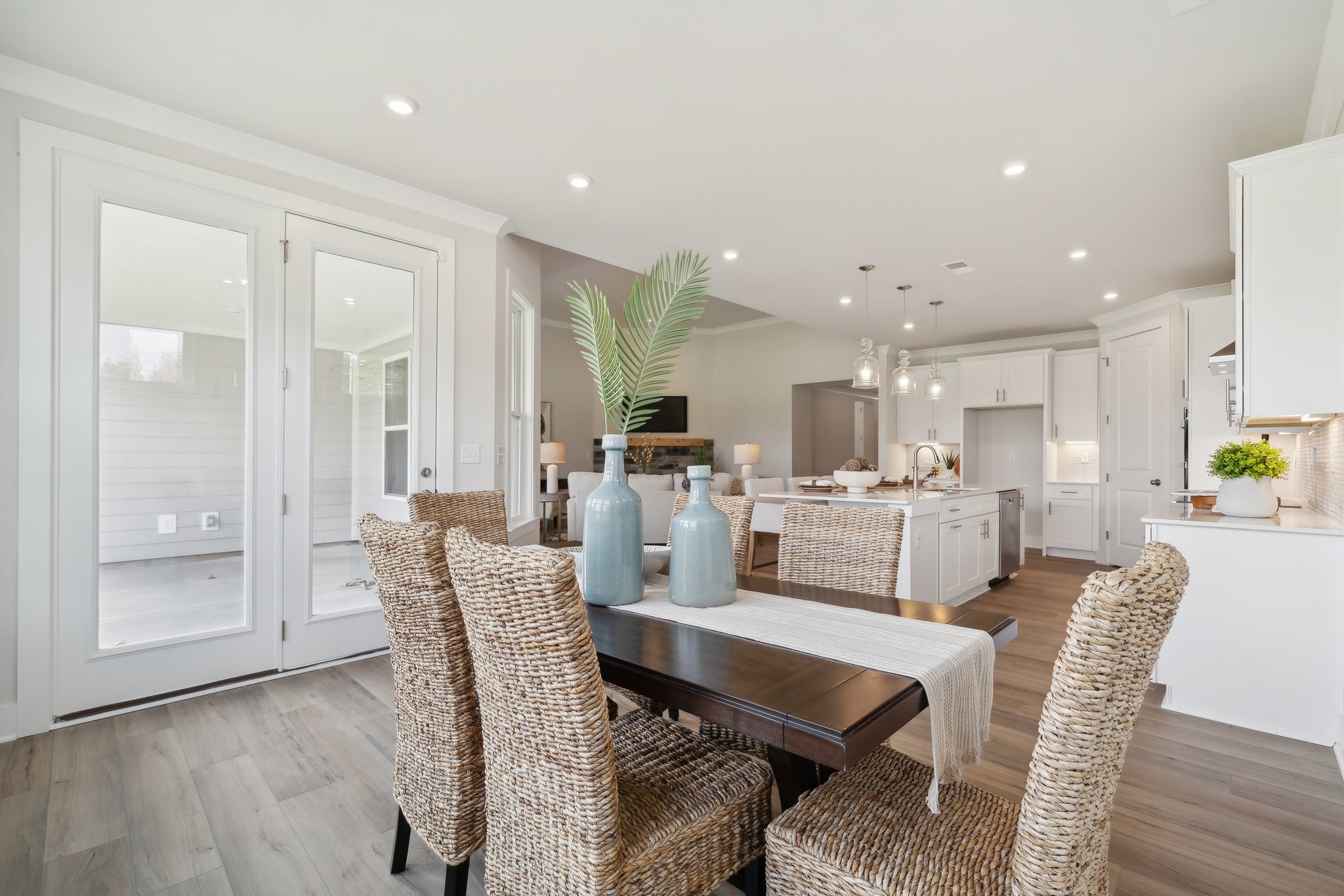 A kitchen with a dining table and chairs.