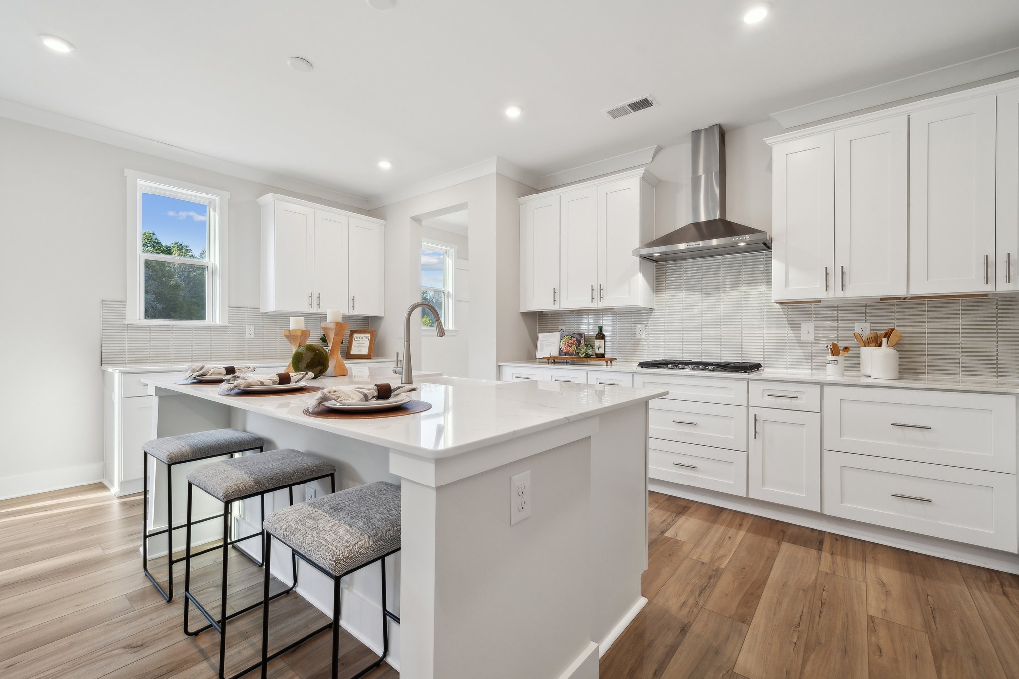 A kitchen with white cabinets.